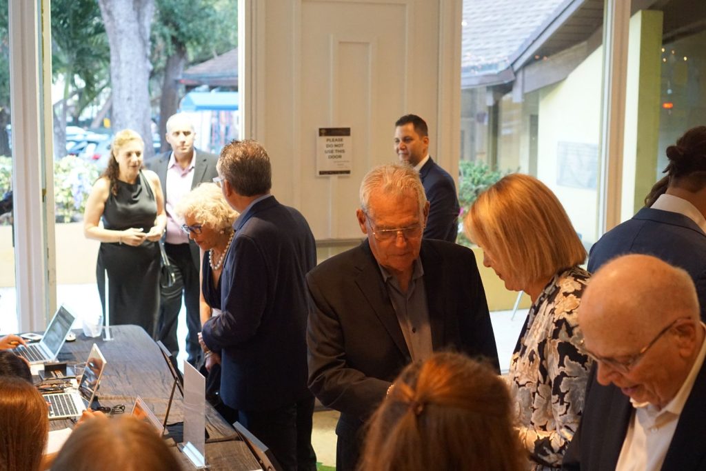 Guests mingling at a Temple Sinai event